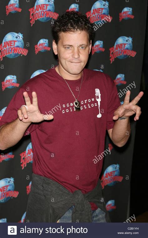 A Man Making The Peace Sign With His Hands