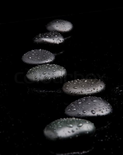 Black Shiny Zen Stones With Water Drops Over Black Background Stock