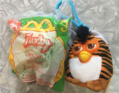 A Stuffed Animal Next To A Bag Of Chips And A Plastic Bag With A Hot