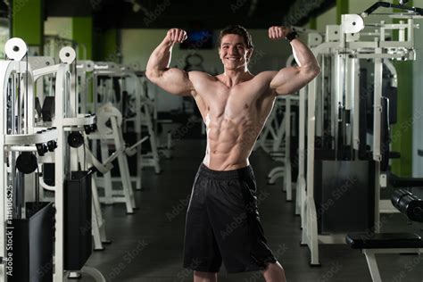 Bodybuilder Flexing Front Double Biceps Pose In Gym Stock Photo Adobe