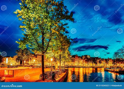 Famous Amstel River And Night View Of Beautiful Amsterdam City