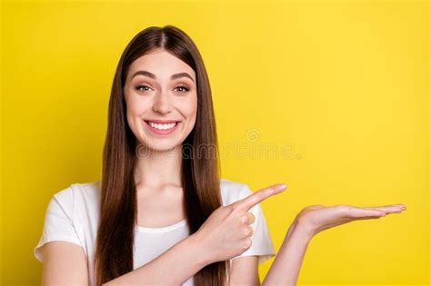 photo portrait of woman pointing finger blank space smiling isolated bright yellow color