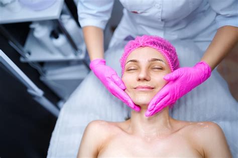 Premium Photo Attractive Female At Spa Health Club Getting A Facial Massage Beautician Doing