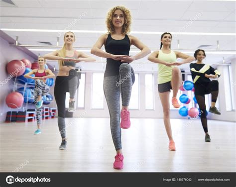 Young Women Exercising In Gym — Stock Photo © Gpointstudio 145576043