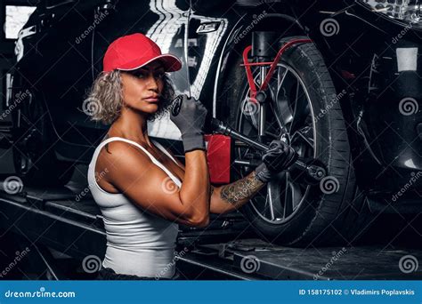Woman Is Fixing Car S Tyre In Auto Servis Stock Photo Image Of Dark