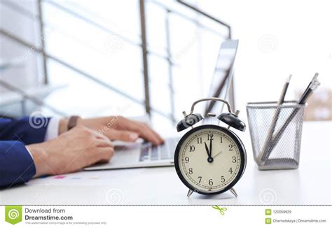 Clock And Blurred Man Working On Background Stock Image