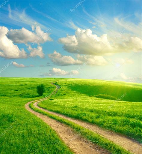 Summer Landscape With Green Grass Road And Clouds Stock Photo By