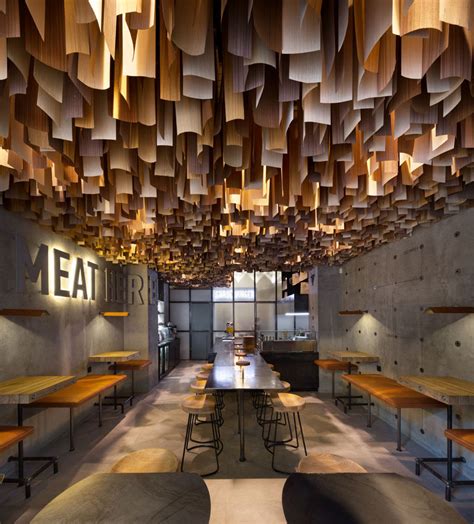 Wood Veneers Suspended From The Ceiling Create A Dramatic Effect Inside