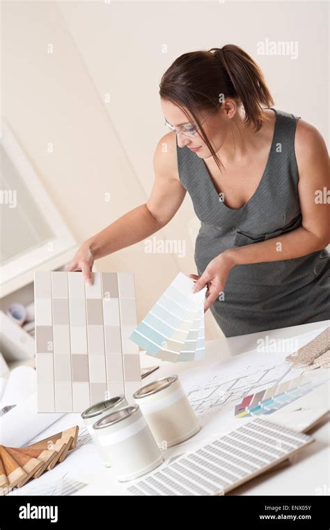 Female Interior Designer Working At Office With Color Swatch Stock