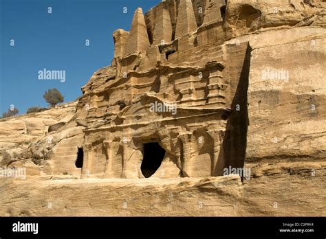 Caves Carved Into Sandstone Mountains In Petra Jordan Stock Photo Alamy