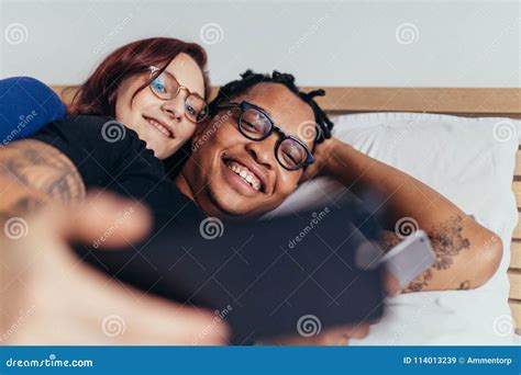 Multiracial Couple Taking Selfie In Bed Stock Image Image Of Phone Lying 114013239