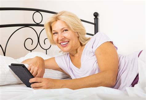Mature Woman Ebook Laying Bed Stock Photos Free Royalty Free Stock Photos From Dreamstime