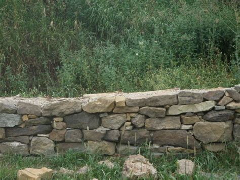 Here's how to build one that will last. Dry-Stack Stone Retaining Wall at New Traditions Homestead ...