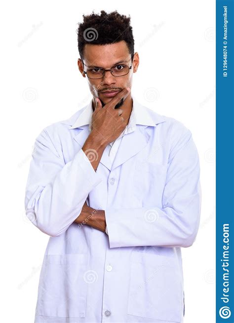 Studio Shot Of Young African Man Doctor Thinking With Hand On Ch Stock