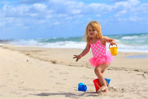 Cute Little Girl Play With Sand On Beach Stock Photo Image Of Shore