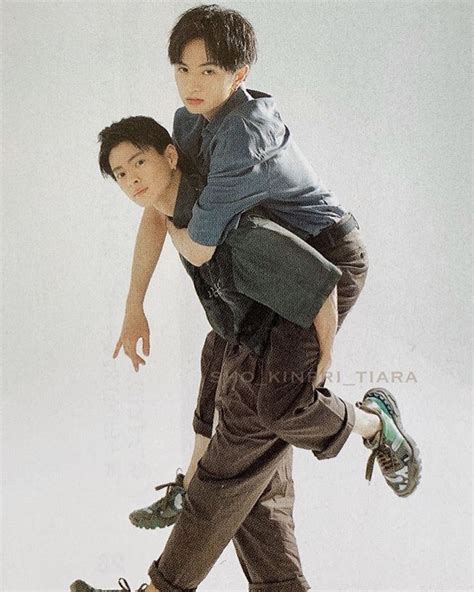 A Man Carrying Another Man On His Back With One Leg In The Air While