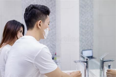 Man Cleans His Razor In The Bathroom With His Wife Stock Image Image Of Male Little 154450647