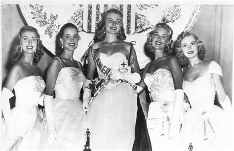 An Old Black And White Photo Of Four Women In Evening Gowns Posing For