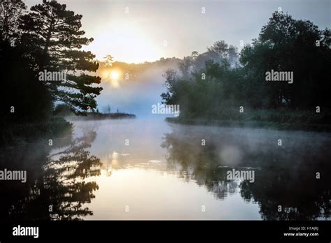 Sun Rises Over A Mist Covered River Test Leckford Hampshire England