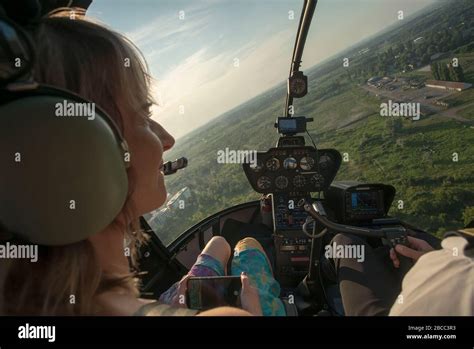 Portrait Of Beautiful Blonde Women Enjoying Helicopter Flight She Is