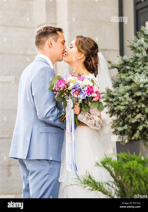 Groom Kissing Bride Outdoors Stock Photo Alamy