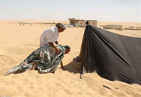 Egyptians Bury Themselves Up To Their Necks For Desert Sand Baths