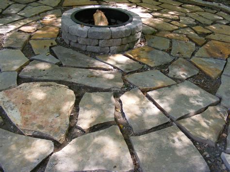 Rotate the pieces until they fit together, working to create a nearly uniform space between the stones. Make a Flagstone Patio