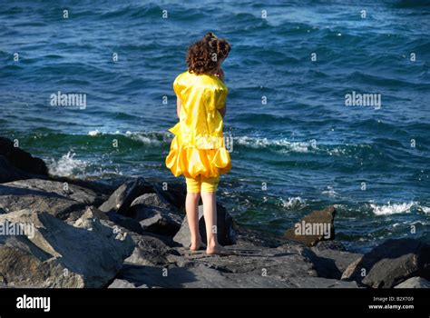 Young Girl Standing Looking Into The Sea Stock Photo Alamy