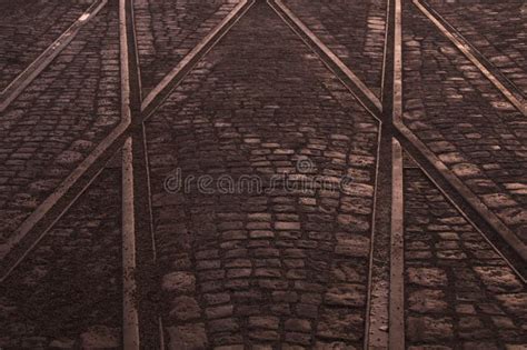 Crossing Of Tram Rails On Stone Pavement In The City Abstract