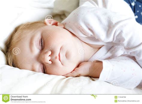 Cute Adorable Baby Girl Of 6 Months Sleeping Peaceful In Bed Stock