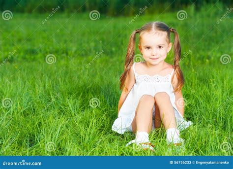 Happy Child Little Girl In White Dress Lying On Grass Summer Stock