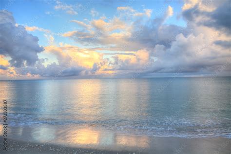 Ocean Rolls In Under Puffy Clouds On North Naples Beach At Sunrise