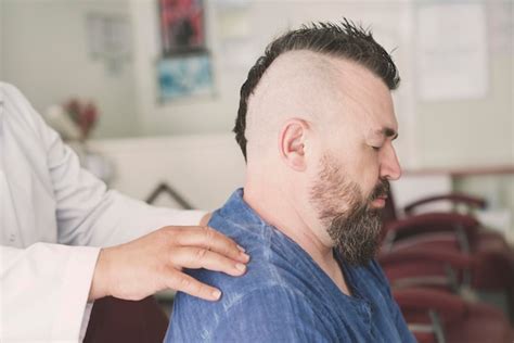 Premium Photo Male Barber Doing Massage Of A Adult Bearded Man With A Mohawk