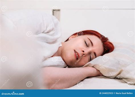 Young Red Haired Woman Asleep On Her Bedroom Bed Stock Image Image