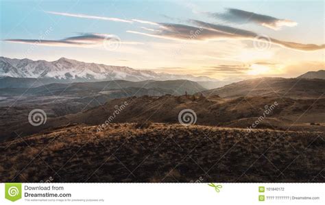Hills And Snowy Mountains At Sunset Stock Photo Image Of Sunlight