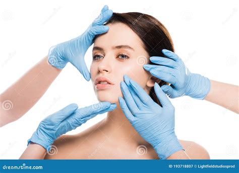 View Of Plastic Surgeons In Blue Latex Gloves Touching Face Of Naked Woman Isolated On White