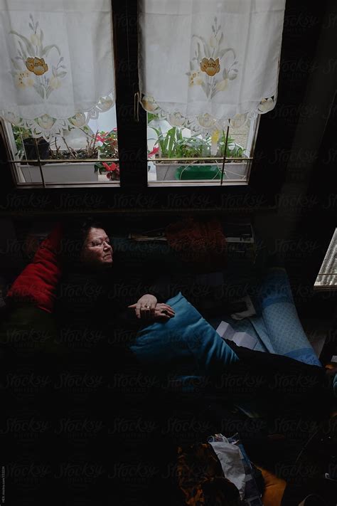 Elderly Woman Relaxing On A Sofa By Stocksy Contributor Mattia