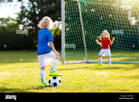 Kids Play Football On Outdoor Field Children Score A Goal During