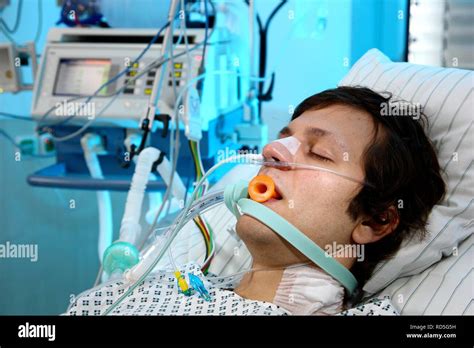 Patient Lying In A Special Bed Intubated Medical Appliances For