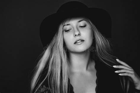 Beautiful Blonde Woman Wearing A Hat Artistic Film Portrait In Black