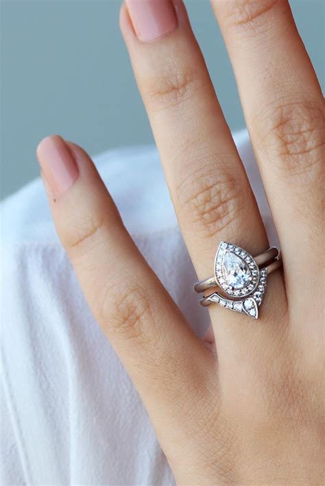 What are the differences between engagement rings, wedding rings and bands and what is the meaning behind them. Pear Shaped Diamond Engagement Ring With Matching Side ...