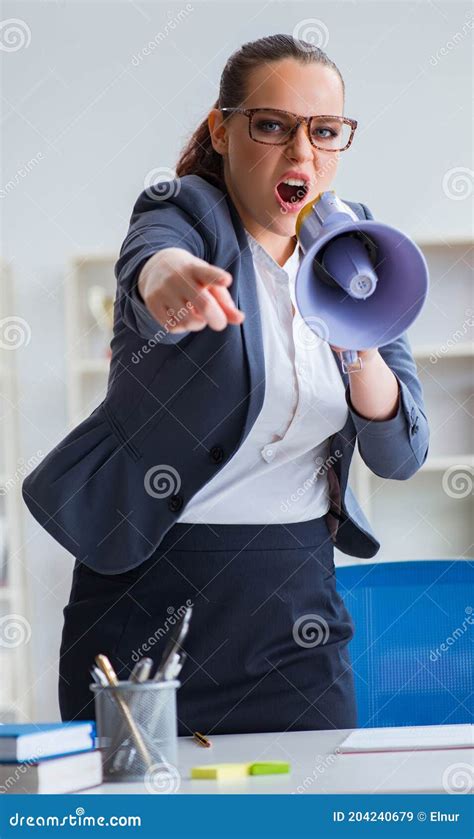 Angry Businesswoman Yelling With Loudspeaker In Office Stock Image