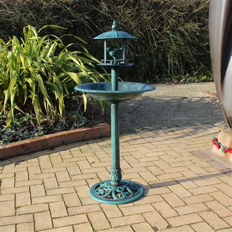 One table top either from a large rock, iron table top, or a round glass table top. Bird Bath With Sheltered Feeding Table | Bonningtons