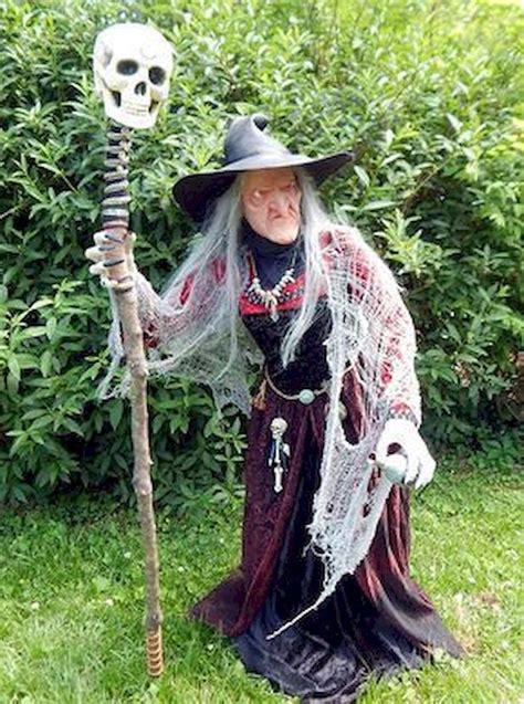 An Old Woman Dressed As A Skeleton Holding A Stick