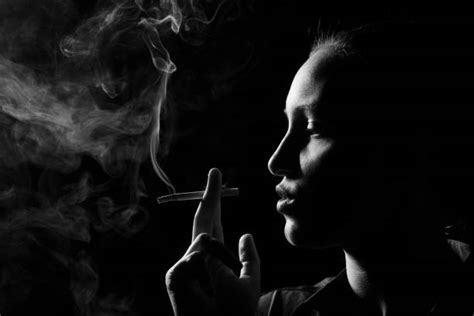 80 Elegant Woman Smoking Cigarette Posing In Studio Bw Portrait Stock
