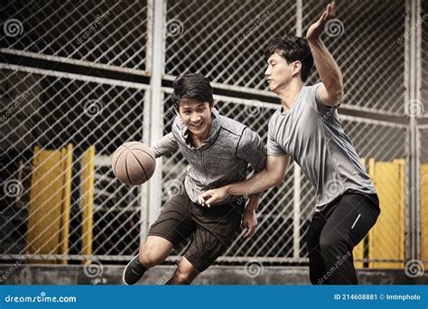 Two Young Asian Men Playing Basketball Outdoors Stock Image Image Of