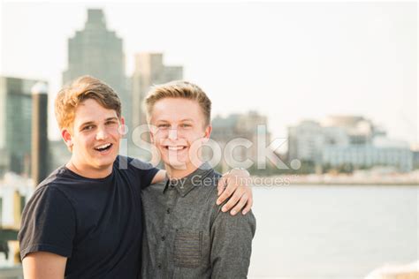 Two Male Friends Pose Overlooking The Harbor Stock Photo Royalty Free