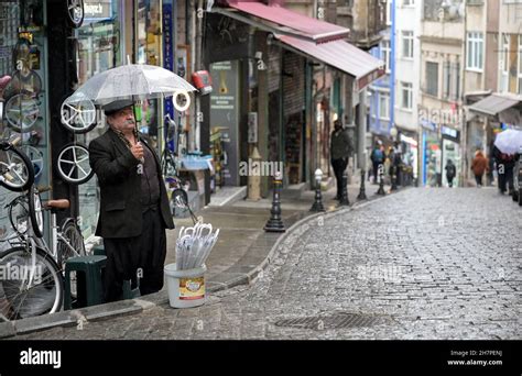 Turkey Istanbul Beyoglu Street Vendor Selling Umbrellas During Rain