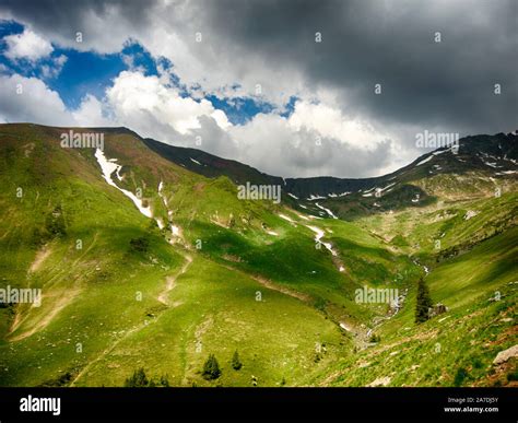 Spectacular Mountain Landscape With Clouds Hovering Above Mountain