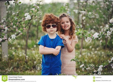 Little Boy And Girl In Blooming Garden Stock Photo Image Of Little